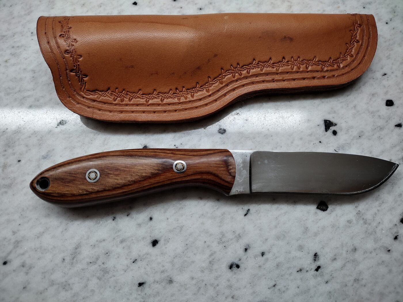 Underside of a basket-weave scout carry sheath showing the wraparound flap that forms the belt loop